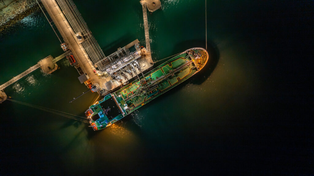 Aerial top view oil tanker ship at terminal industrial port at n